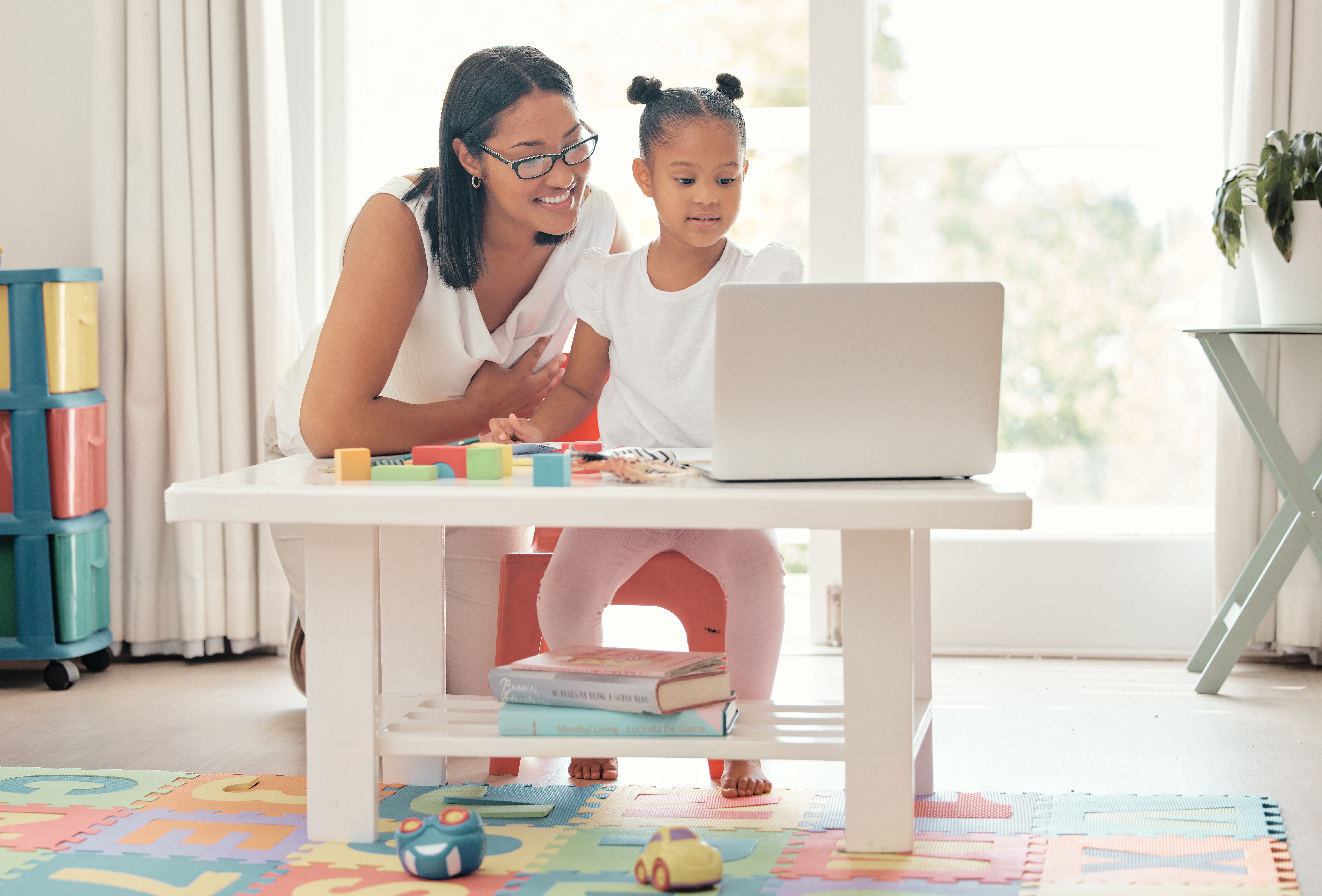 Parent and child participating in virtual evaluation